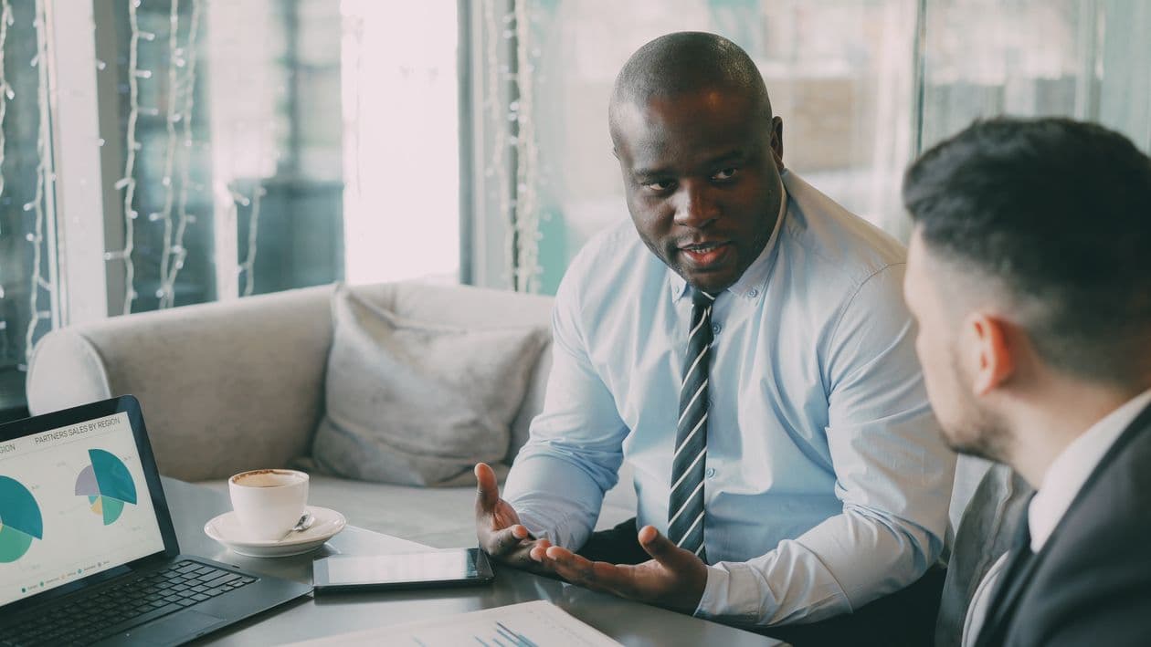 Advisors discussing investment strategy over a meeting