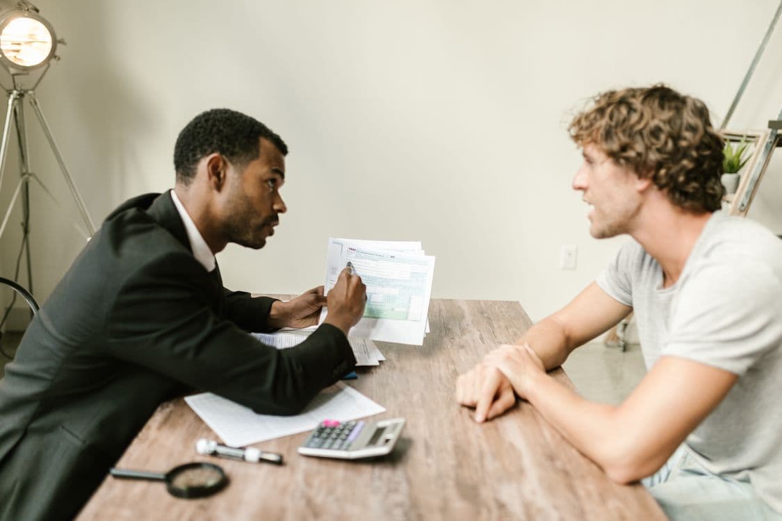 Financial advisor discussing wealth management documents with a client