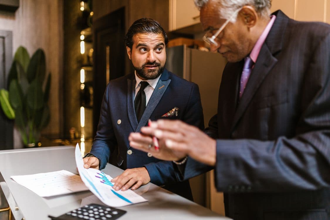 Business owners discussing tax strategy documents